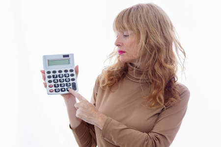 middle-aged isolated woman with calculatorの写真素材
