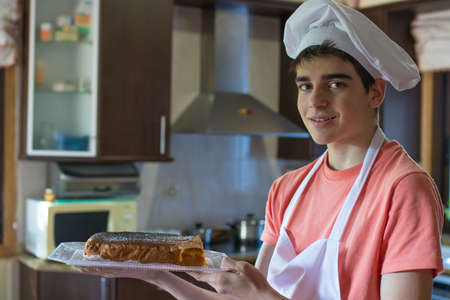 young chef with freshly made sweet or cake