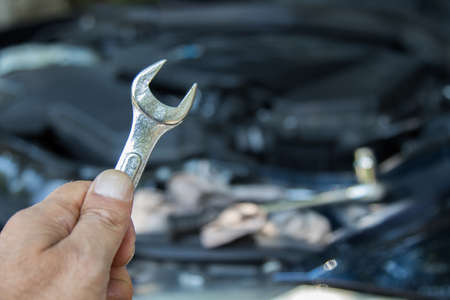 hand with car mechanic workshop toolsの写真素材