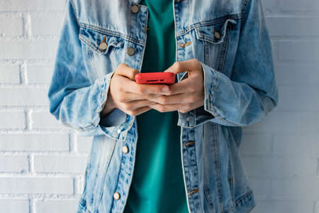 urban young hands with mobile phone in foregroundの写真素材