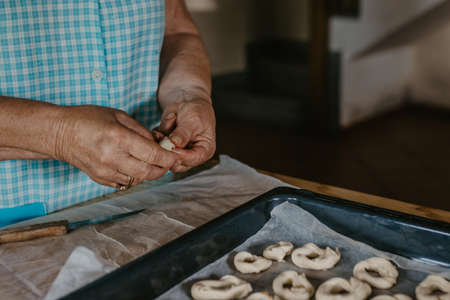 woman hands preparing sweets or donuts with traditional recipe at homeの写真素材