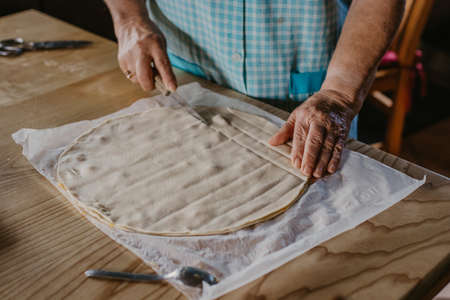 hands kneading the mixture or dough for bread or traditional cuisine dessertsの写真素材