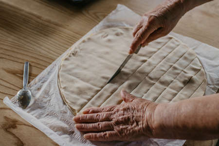 hands kneading the mixture or dough for bread or traditional cuisine dessertsの写真素材