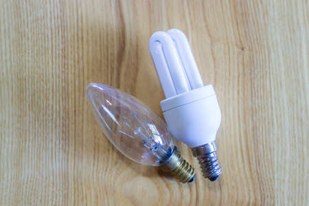 traditional and energy saving light bulb