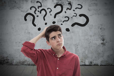 portrait of young man or teenager with questions