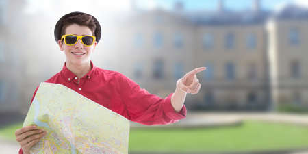 young man with sunglasses and hat, tourists and travel mapの写真素材