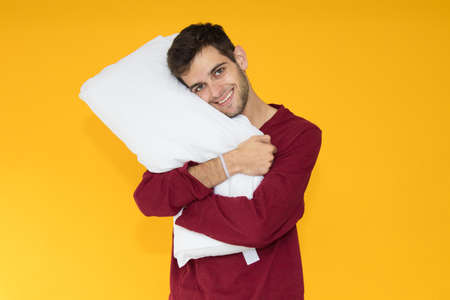 young man pillow isolated on color backgroundの写真素材