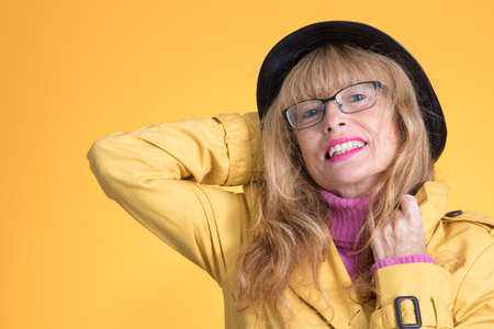 elegant adult woman with autumn style on color backgroundの写真素材