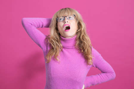 adult woman isolated on color background with expression of stress and painの写真素材