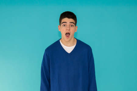 portrait of young teenage man with surprise expression