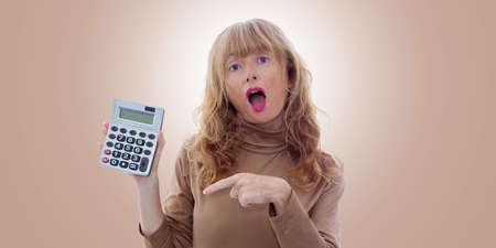 adult woman with calculator isolated on backgroundの写真素材