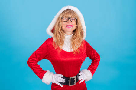 beautiful blonde santa claus woman isolated on color backgroundの写真素材