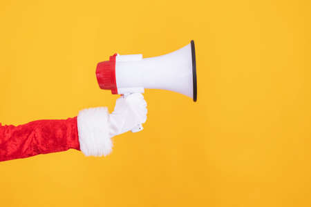 santa claus hand with loudspeaker or megaphone isolatedの写真素材