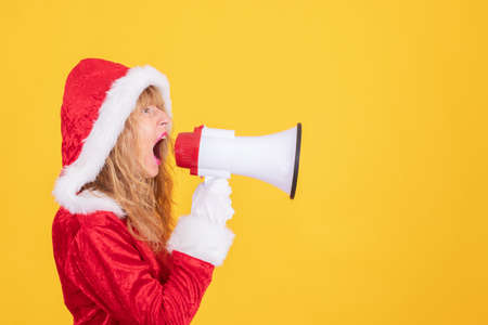 santa claus woman with megaphone screaming isolatedの写真素材