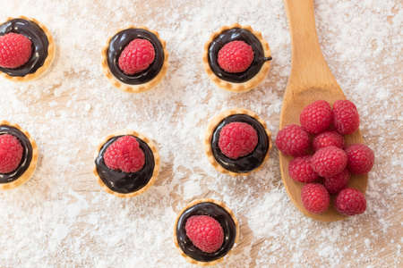 chocolate and raspberry cakes and candiesの写真素材