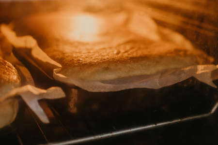 traditional homemade cake or sponge cake baking inside the ovenの写真素材