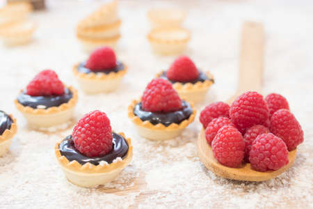 chocolate and raspberry cakes and candiesの写真素材