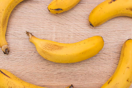 background of natural bananas on woodの写真素材