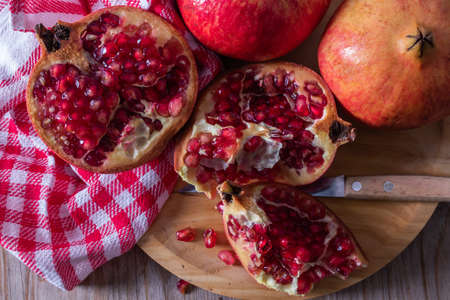 fresh ripe red pomegranate open on plateの写真素材