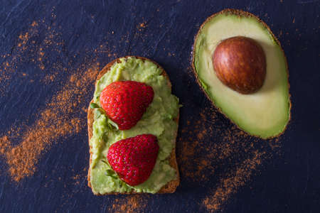avocado on toast on black background, guacamoleの写真素材