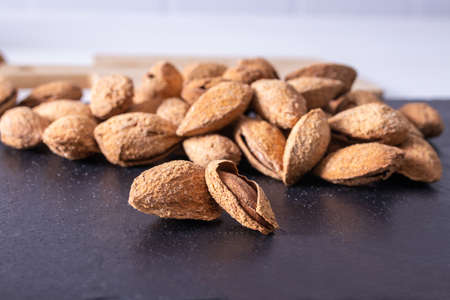 almonds isolated on stone backgroundの写真素材