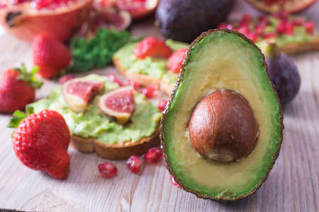 avocado and red fruit toasts from the vegan or vegetarian dietの写真素材