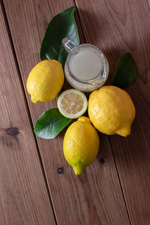 top view of natural lemons with leaves and lemon juiceの写真素材