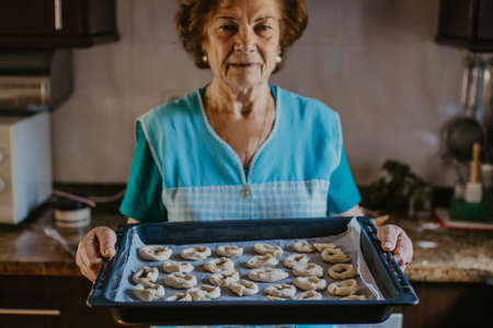 grandmother with tray of sweets and homemade dessertsの写真素材