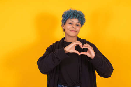 isolated girl with hand in heart as a sign of love or healthの写真素材