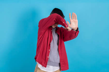 trendy teen boy or student in urban fashion isolated on color background