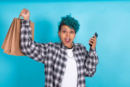 isolated woman or girl with shopping bags and mobile phoneの写真素材