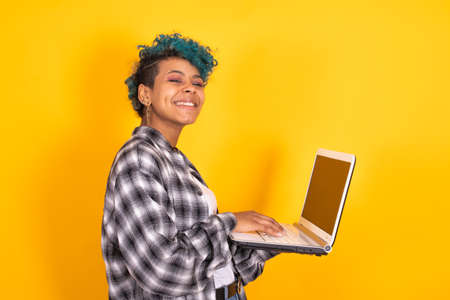 woman or girl with laptop computer isolated on color backgroundの写真素材
