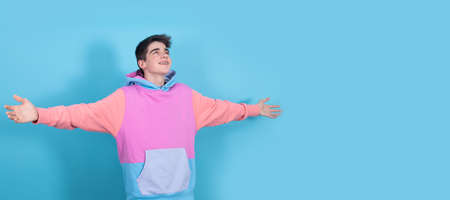 young teenage man or student isolated with open armsの写真素材