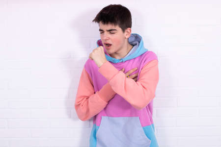 young teenage man with coughing or constipated expression