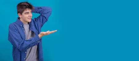 young male teenager or student in casual style isolated on color backgroundの写真素材