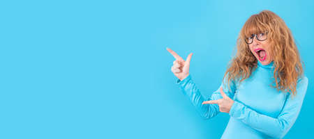 adult or senior woman isolated on blue background
