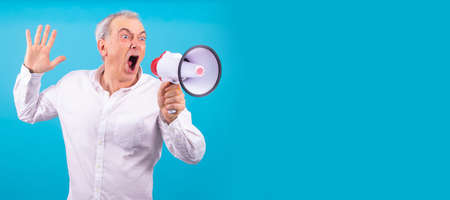 man with megaphone yelling isolated on color backgroundの写真素材