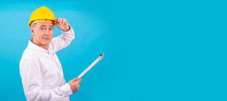 man isolated on color background with construction helmetの写真素材