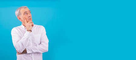 senior man with white shirt isolated on color backgroundの写真素材