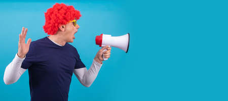 man with funny wig isolated on color backgroundの写真素材