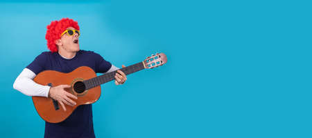 man with funny wig isolated on color backgroundの写真素材