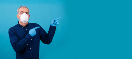 isolated adult man with face mask pointing backgroundの写真素材