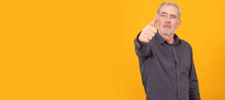 isolated adult or senior man with thumb upの写真素材