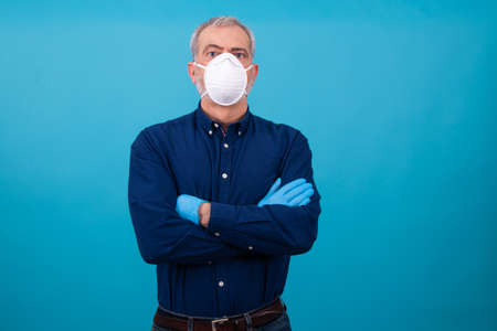 adult man with mask and gloves isolated on color background