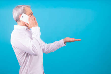 adult business man with mobile phone isolated on backgroundの写真素材