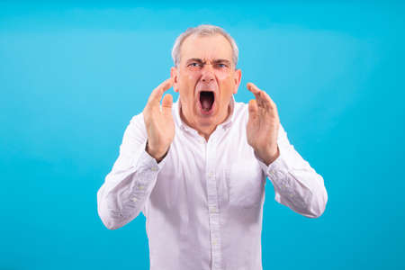 senior man with white shirt isolated on color background