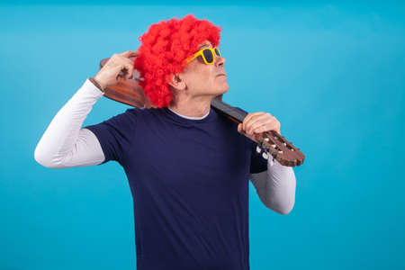 man with funny wig isolated on color backgroundの写真素材