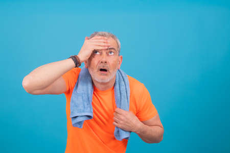 adult man with sportswear and expression of stress or tirednessの写真素材