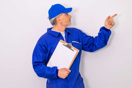 worker isolated on white background pointing blank spaceの写真素材