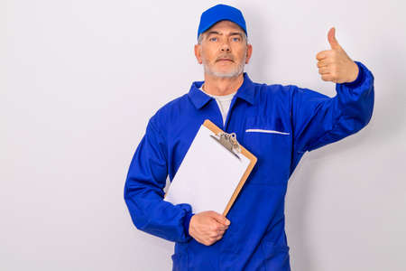 technician or professional with approval gesture isolated on white backgroundの写真素材